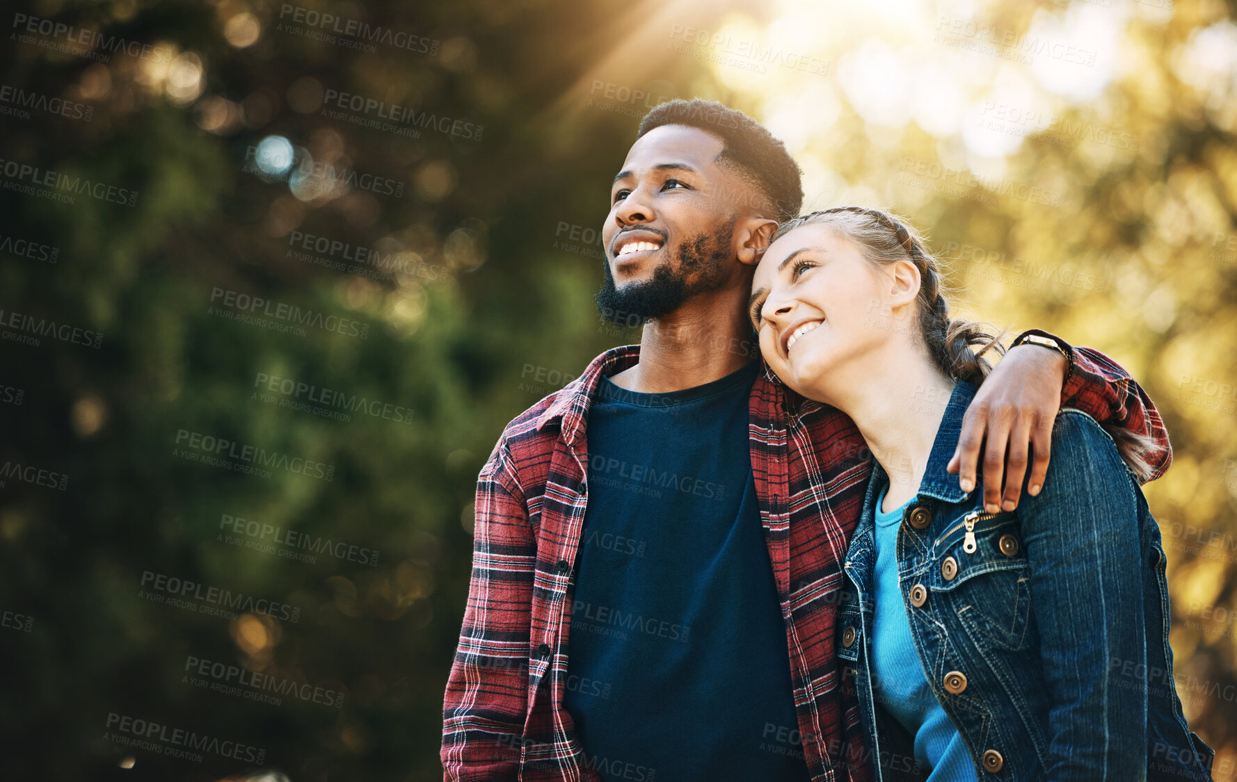 Buy stock photo Love, interracial and couple in nature, freedom and happiness with romance, carefree and bonding together. Romantic, black man and woman hug, loving and outdoor for fun, relationship and cheerful