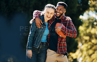 Buy stock photo Love, diversity couple and laughing in nature, having fun and playing football outdoors. Comic, interracial romance and happy black man and woman hug, laugh at funny joke and enjoying time together.