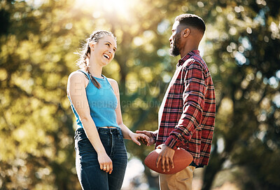 Buy stock photo Couple, American football in park and happy together, summer with hand holding outdoor and sports in the sun. Commitment, trust and fitness, black man and woman, interracial relationship and care