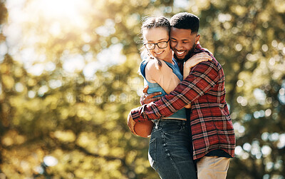Buy stock photo Football, love and interracial couple with a hug in nature for sports, playful and bonding. Affection, happy and black man and woman hugging for rugby, sport and playing with mockup space in a park