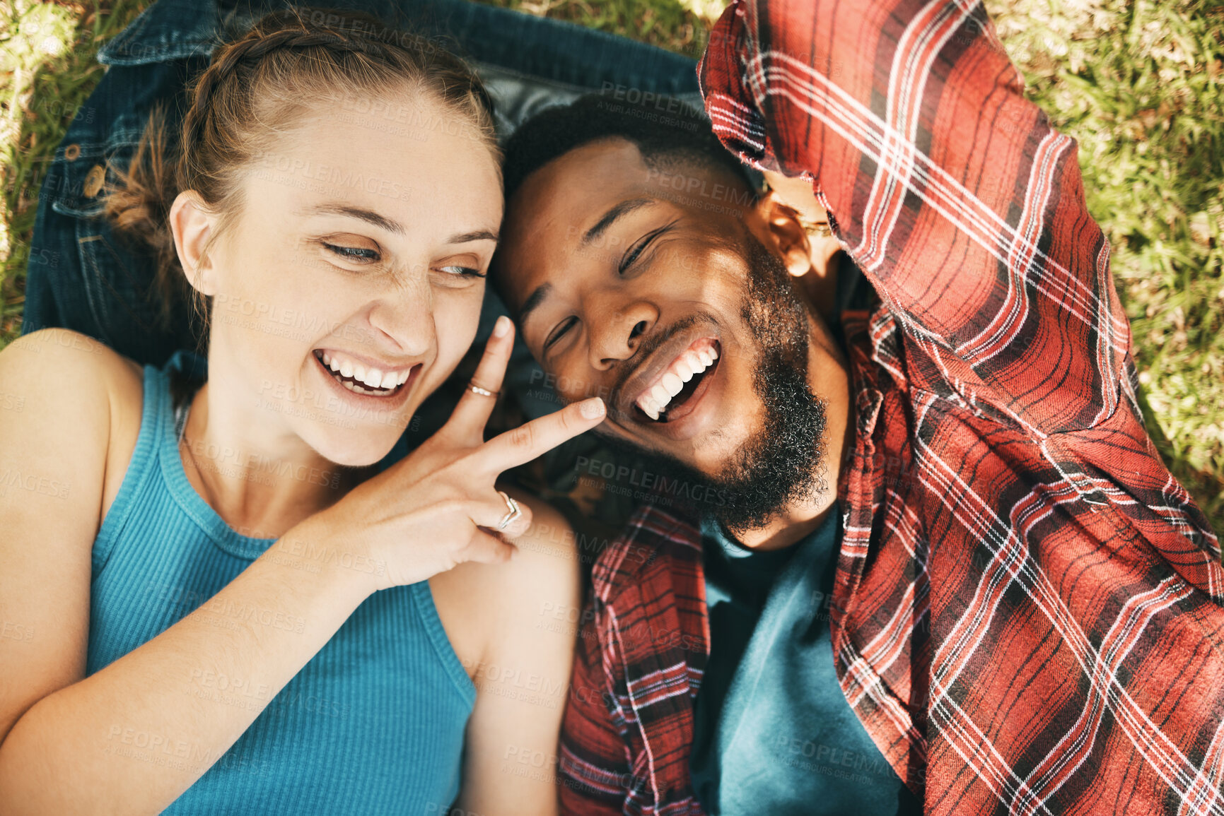 Buy stock photo Interracial couple, park selfie and peace on grass with love, happiness and relax on holiday. Black man, woman and profile picture on lawn for social network app with romance, funny and comic time