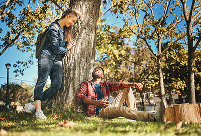 Buy stock photo Relax, together and interracial couple on a park date for love, anniversary and happiness in Italy. Smile, conversation and black man and woman speaking while in nature for peace, relaxing and care