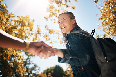 Buy stock photo Woman, smile and holding hands in nature with backpack for travel, trip or couple adventure. Happy female touching hand smiling in park with bag for summer bonding, traveling or outdoor holiday break