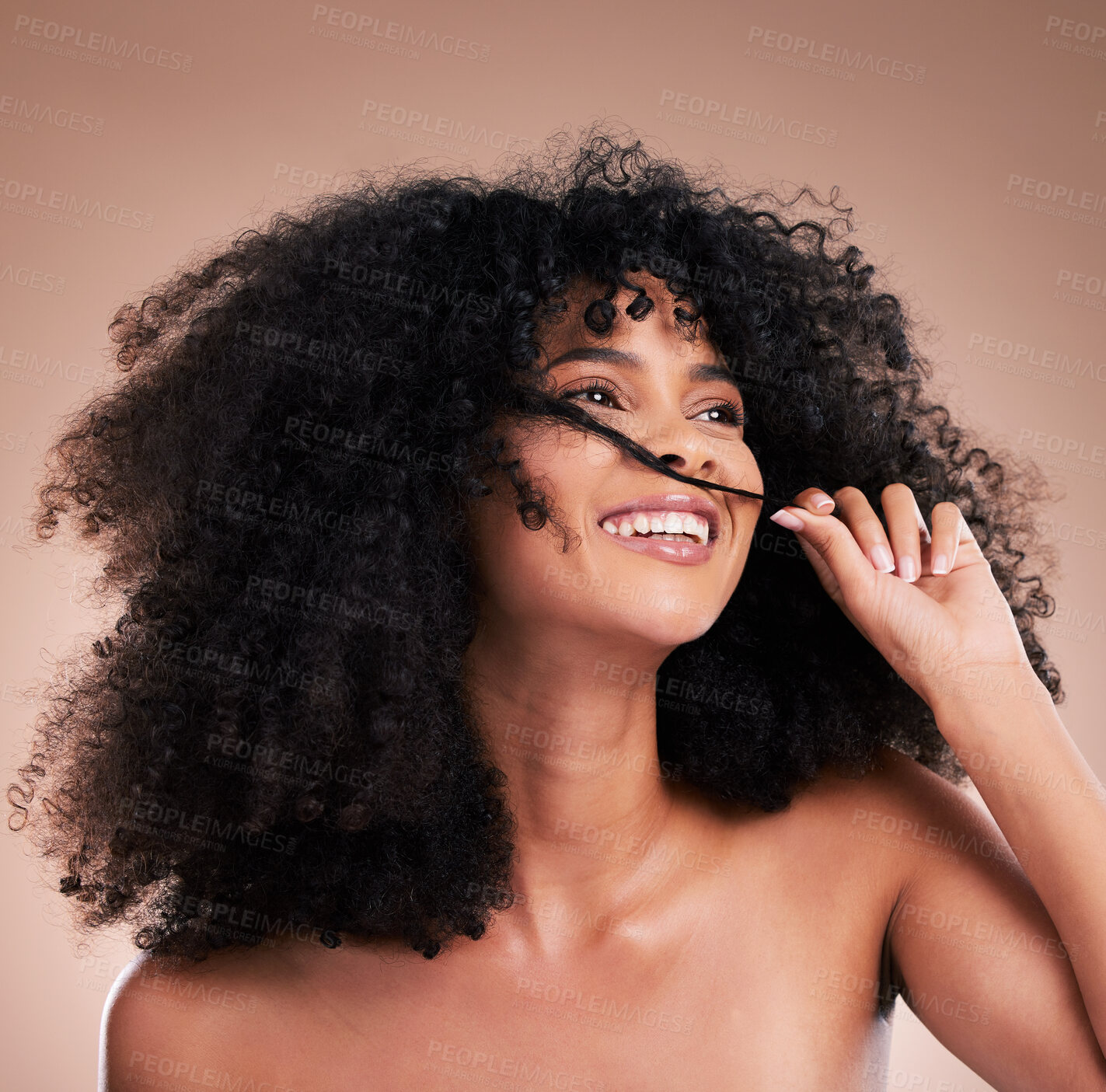 Buy stock photo Afro, beauty and face of black woman with hair in hands on brown background for wellness, shine and natural glow. Salon, luxury treatment and happy girl smile with curly hairstyle, texture and growth