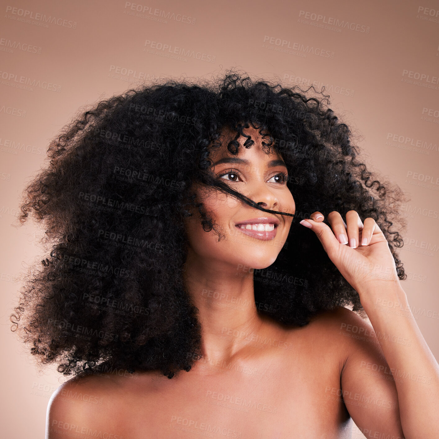 Buy stock photo Hair in hands, beauty and black woman with smile on brown background for wellness, shine and natural glow. Salon, luxury treatment and happy girl face with curly hairstyle, texture and afro growth