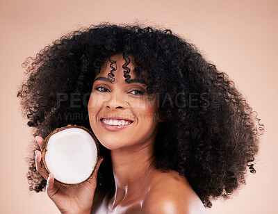 Buy stock photo Black woman, studio portrait and coconut for beauty, smile and skincare for health, wellness or beige background. Happy african model, natural and fruit for aesthetic, healthy nutrition and cosmetics