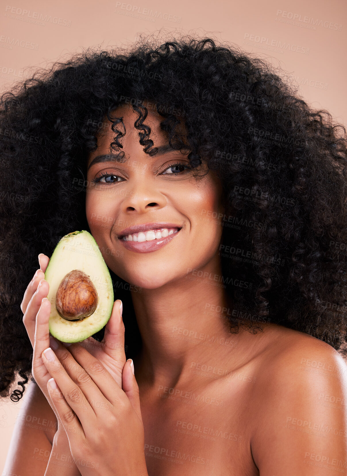 Buy stock photo Face portrait, hair care and black woman with avocado in studio isolated on a brown background. Food, skincare and happy female model with fruit for healthy diet, nutrition or vitamin c and minerals.
