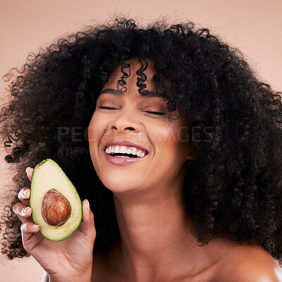 Buy stock photo Black woman, studio and avocado for beauty, smile and skincare with health, wellness and self care by background. Happy gen z model, african and fruit for natural aesthetic, healthy nutrition or diet