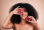 Black woman, studio portrait and pomegranate for beauty, smile or skincare for health, wellness and glow by background. Happy gen z model, african or fruit for natural aesthetic, nutrition and diet