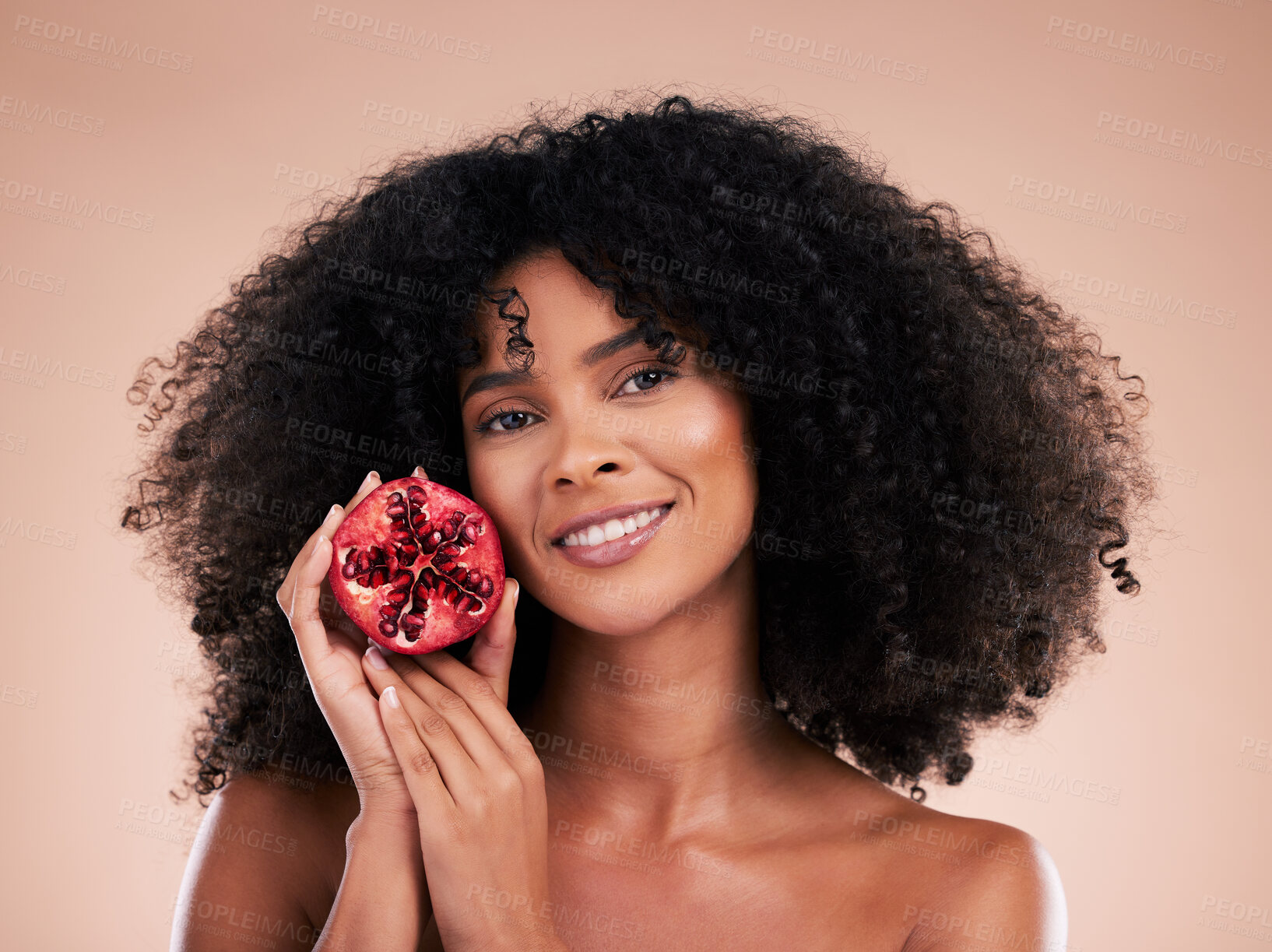Buy stock photo Hair care, face and portrait of black woman with pomegranate in studio isolated on a brown background. Fruit, skincare and happy female model holding food for healthy diet, nutrition and vitamin c.