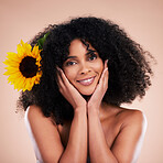 Black woman, studio portrait and sunflower with beauty, smile and cosmetic wellness by beige background. African gen z model, flower and spring aesthetic with hands, happy and natural makeup on face