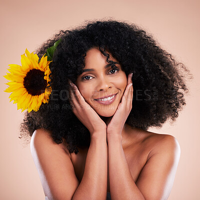 Buy stock photo Black woman, studio portrait and sunflower with beauty, smile and cosmetic wellness by beige background. African gen z model, flower and spring aesthetic with hands, happy and natural makeup on face