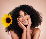 Black woman, studio portrait and sunflower with skincare, beauty or cosmetic wellness by beige background. African gen z model, flower and spring aesthetic with happiness, self care or natural makeup