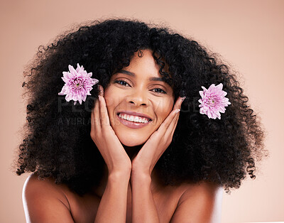 Buy stock photo Face, portrait and black woman with flowers for hair care in studio isolated on a brown background. Floral cosmetics, hairstyle makeup and beauty of happy female model with plant for salon treatment.