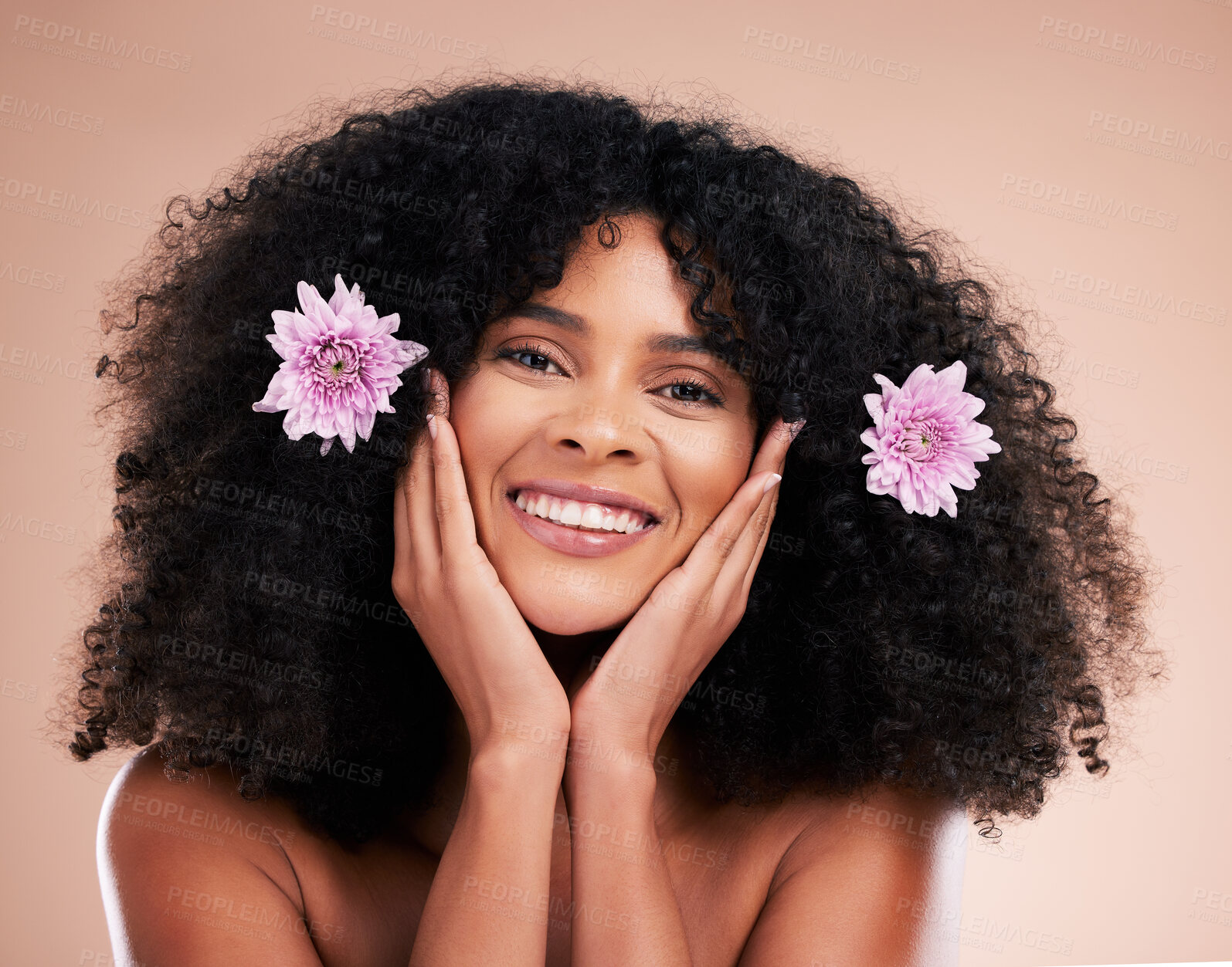 Buy stock photo Face, portrait and black woman with flowers for hair care in studio isolated on a brown background. Floral cosmetics, hairstyle makeup and beauty of happy female model with plant for salon treatment.