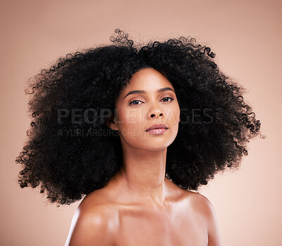 Buy stock photo Beauty, hair and portrait of black woman with afro on brown background for wellness, shine and natural glow. Salon, luxury treatment and serious face of girl for curly hairstyle, cosmetics and growth