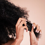 Beauty, hair texture and hands of black woman in studio for self care with shampoo for growth. Aesthetic model person with natural curly afro background with cosmetic and salon or hairdresser results