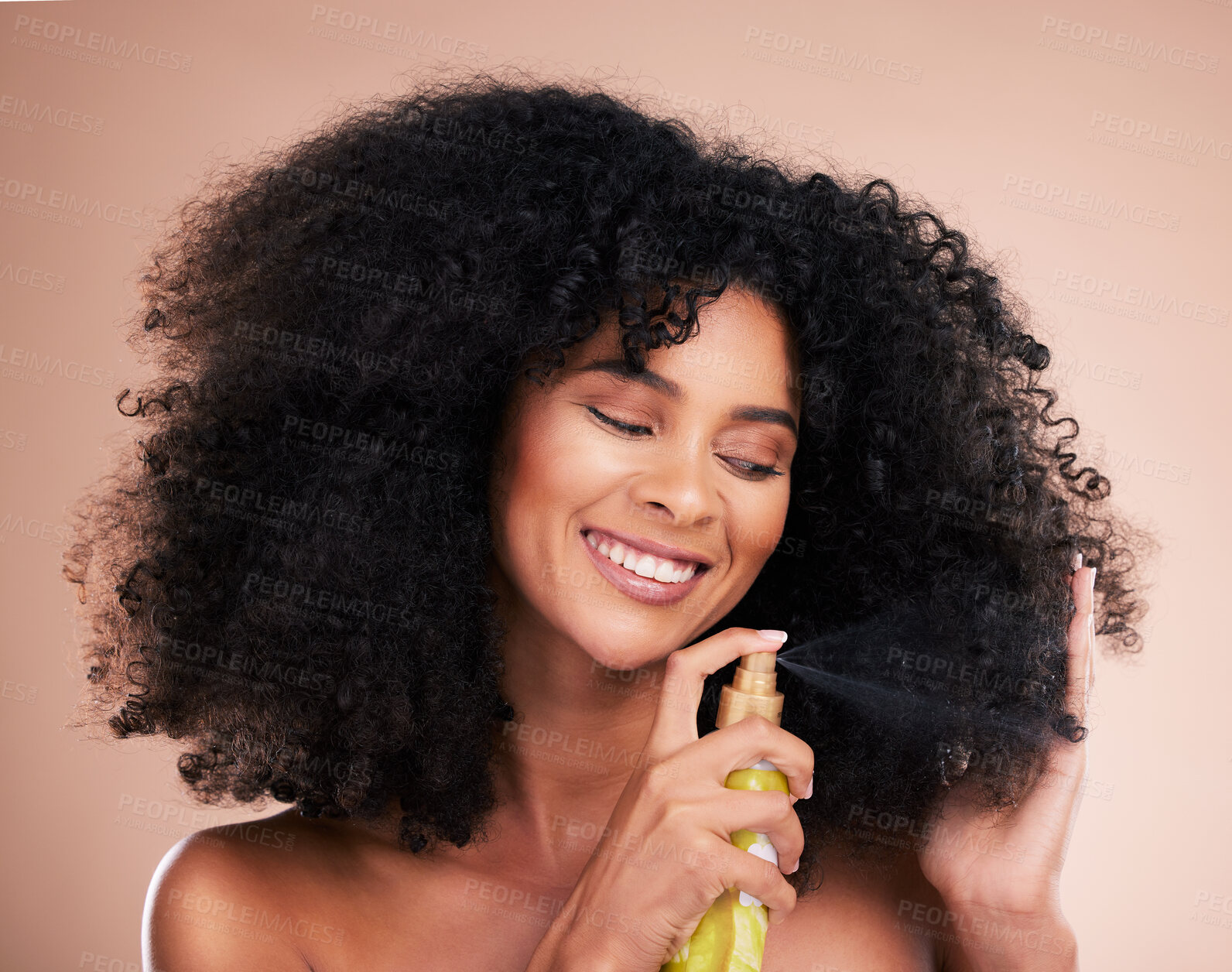 Buy stock photo Model, happy or afro hair spray on isolated studio background in frizz control, curly management or oil treatment. Black woman smile, face or natural haircare product for grooming or texture wellness