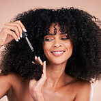 Hair care, oil and face of black woman in studio for self care with keratin for growth. Happy aesthetic model person with natural curly afro and salon product for shine, health and wellness benefits