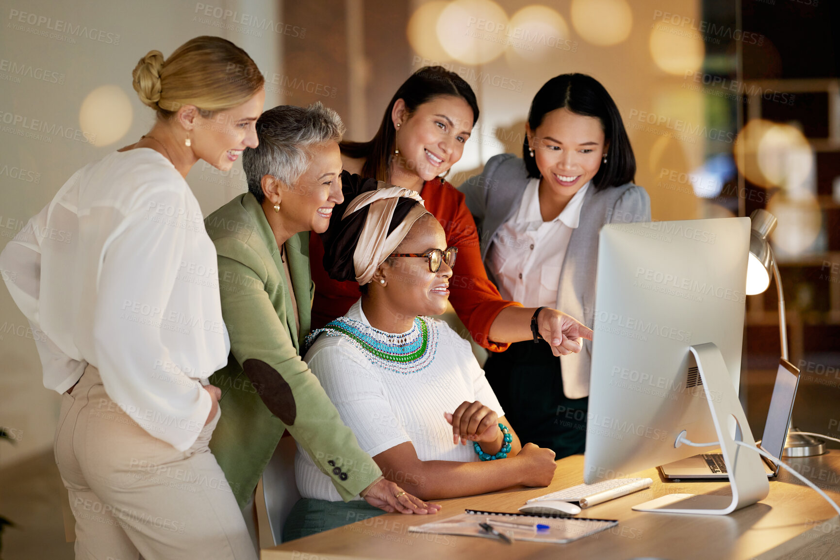 Buy stock photo Computer, management and a business woman with her team, working on a deal in the office at night. Collaboration, diversity and coaching with a senior female manager training her staff at work