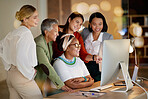 Collaboration, meeting and a business woman with her team, working on a computer in the office at night. Teamwork, diversity and coaching with a senior female manager training her staff at work