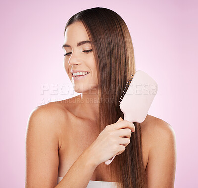 Buy stock photo Beauty, woman with smile and hair with brush, skin glow with skincare, face and dermatology on pink background. Keratin treatment, shine and natural cosmetics with hand, hairstyle and haircare