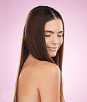 Hair, beauty and woman with haircare, face and skin glow with keratin treatment on pink background. Cosmetics shine, grooming and hairstyle, cosmetic care and female content with skincare and smile