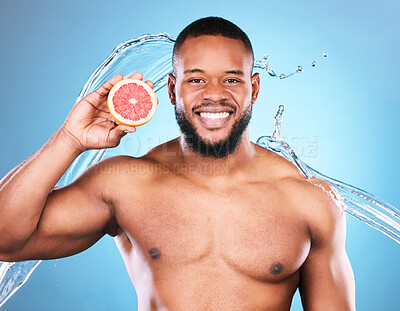 Buy stock photo Portrait, happy or black man with grapefruit for facial skincare cleaning, vitamin c or cosmetic benefits in studio. Smile, dermatology or young male beauty model cleaning a glowing face for wellness