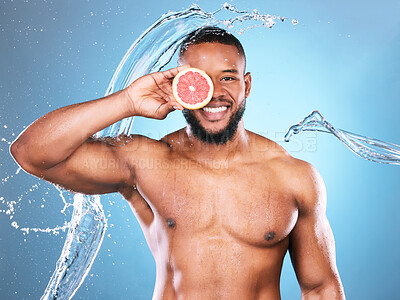 Buy stock photo Portrait, water splash or black man with grapefruit for skincare facial cleaning with vitamin c benefits in studio. Happy smile, healthy or young male beauty model with a glowing face for wellness
