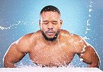 Water splash, cleaning or black man with face wash for skincare, fresh clean hygiene on studio background. African model in beauty, wellness and washing, grooming  or cleansing for facial treatment