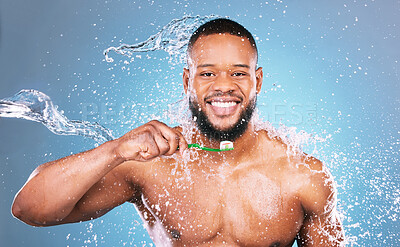 Buy stock photo Black man, face and toothbrush with water and dental, brushing teeth and hygiene on blue background. Cleaning, wet splash and grooming, male in portrait and smile for oral care product and toothpaste