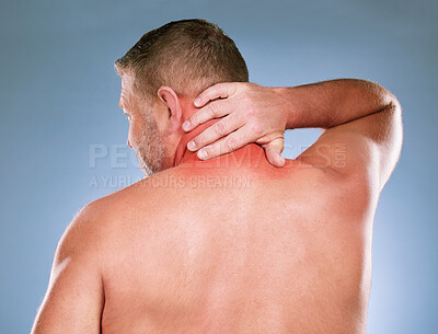 Buy stock photo Back, senior man and neck pain with stress, emergency and guy against blue studio background. Mature male, gentleman and injury with muscle strain, tension and burnout with first aid and suffering