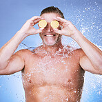 Lemon in hands, water splash and man with face, beauty and skincare, eco friendly and organic on blue background. Hydration, vitamin c and hygiene with senior male, smile and citrus fruit with skin