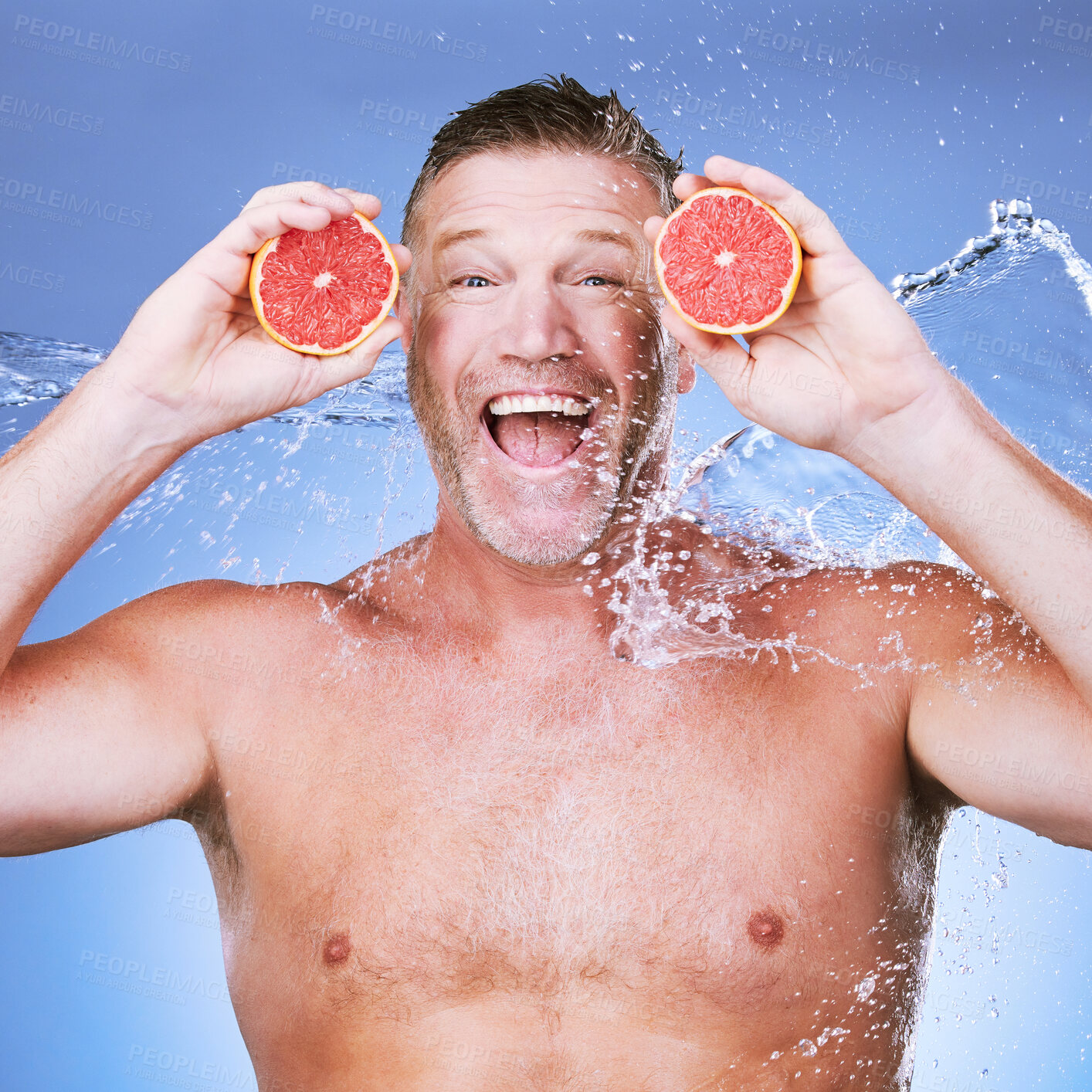 Buy stock photo Excited man, grapefruit in hands and water in portrait, beauty skincare, eco friendly and vegan cosmetics on blue background. Hydration, vitamin c and hygiene, senior male smile and citrus fruit