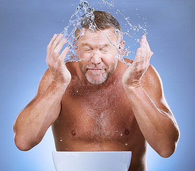 Buy stock photo Man cleaning face, hands and water with hygiene and grooming with clean facial on blue background. Senior male washing skin, basin and beauty with natural cosmetic care, splash and dermatology