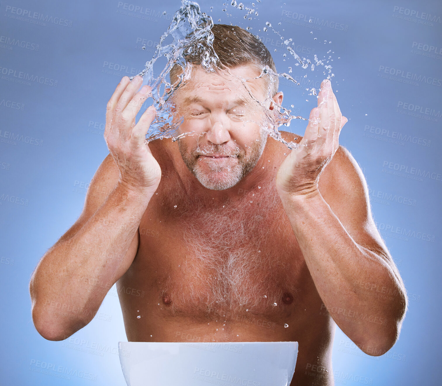 Buy stock photo Man cleaning face, hands and water with hygiene and grooming with clean facial on blue background. Senior male washing skin, basin and beauty with natural cosmetic care, splash and dermatology