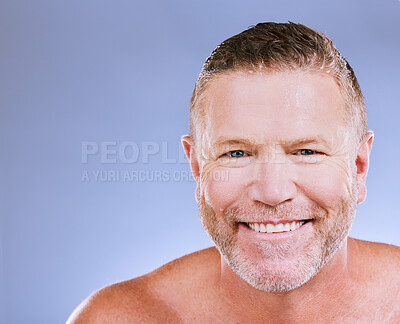 Buy stock photo Skincare, man smile and portrait of a mature model in a blue background studio with mockup. Facial, cosmetics wellness and spa treatment of a senior person with happiness from self care cleaning