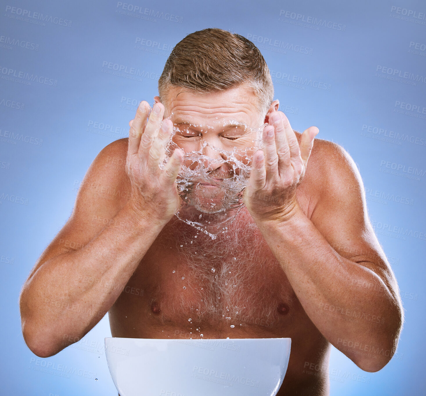 Buy stock photo Man cleaning face, hands and water splash, hygiene and grooming with clean facial on blue background. Senior male washing skin, basin and morning routine with natural cosmetic care and dermatology