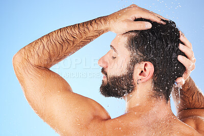 Buy stock photo Man, shower and hair wash of a model in water for cleaning, skincare and hygiene wellness. Isolated, blue background and studio with a young person in bathroom for dermatology and self care routine