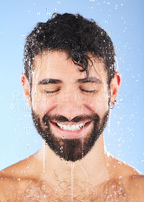 Buy stock photo Man, shower water and smile of a model for beauty cleaning, skincare and hygiene wellness. Isolated, blue background and studio with a young person in bathroom for dermatology and self care routine