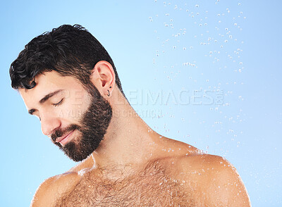 Buy stock photo Man, water drop and shower for hygiene, self care and cleaning on a blue background in studio. face of a aesthetic model person for skincare health and wellness with splash for dermatology cosmetics