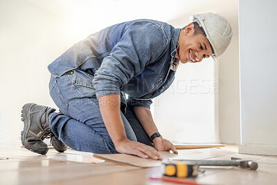 Buy stock photo Handyman, wood flooring installation and happy at workplace, industry and home development vision. Black man, construction worker and floor with smile, helmet and tools for diy, interior and design