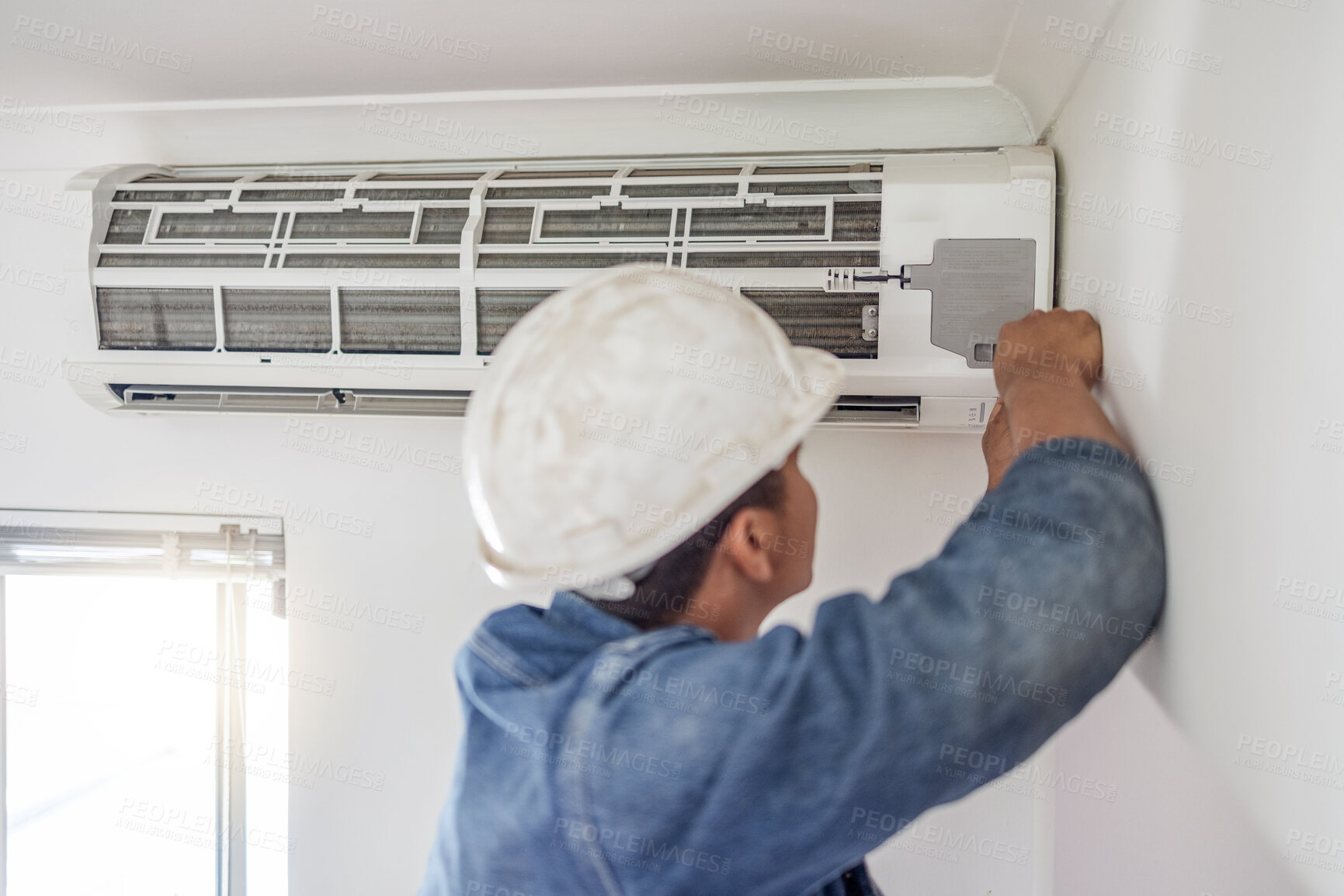 Buy stock photo Air conditioner, ac repair and building hvac maintenance of a handyman and builder on home renovation. Electric technician, service worker and contractor in a house for equipment installation on wall