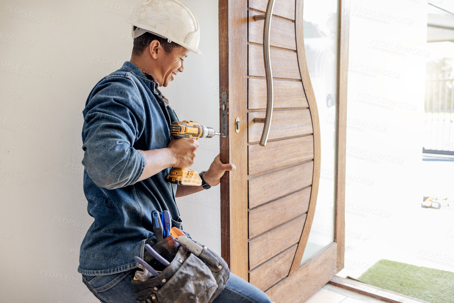 Buy stock photo Locksmith, man and maintenance, handyman with home renovation and fixing, change door locks with power tools. Construction, building industry and trade with manual labour, vocation and employee