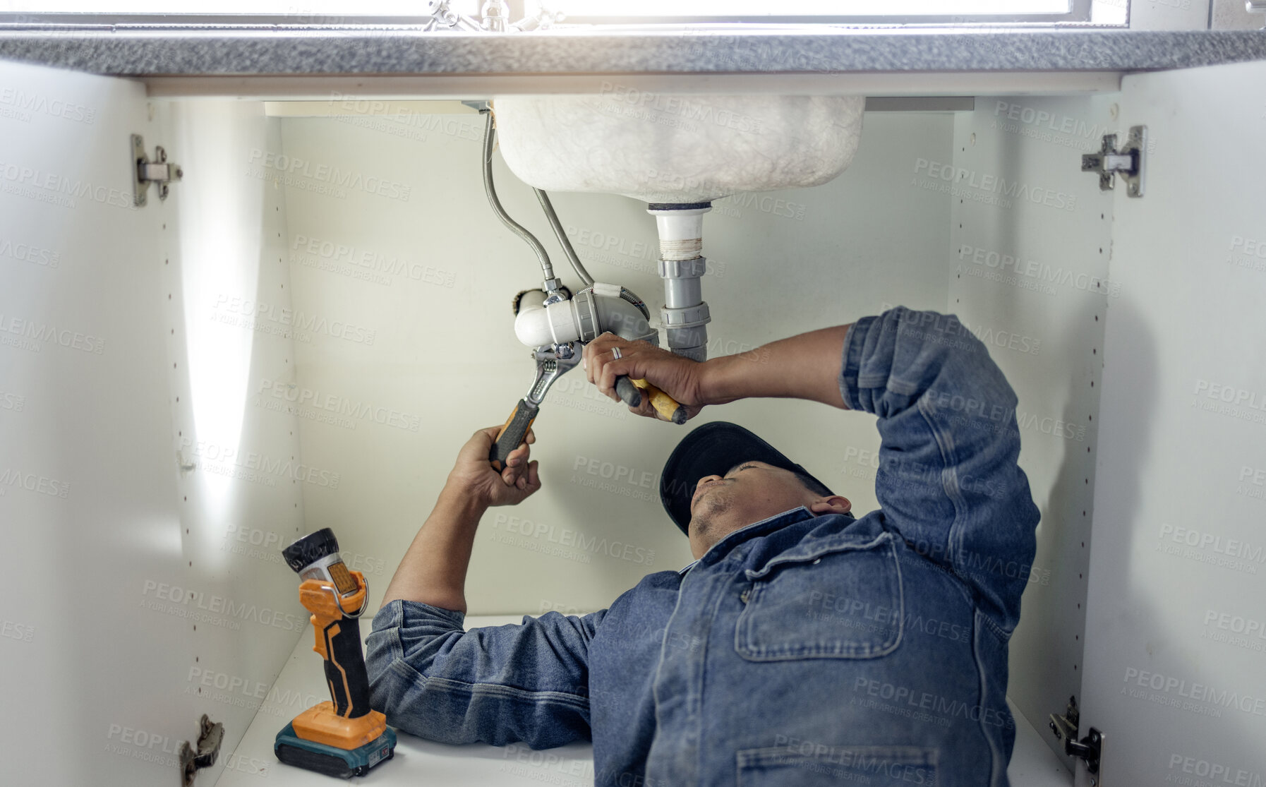 Buy stock photo Plumber, man and handyman with plumbing, home renovation and manual labour with tools. Construction, DIY skills and professional, fixing pipe in industry and male with trade, repairs and maintenance