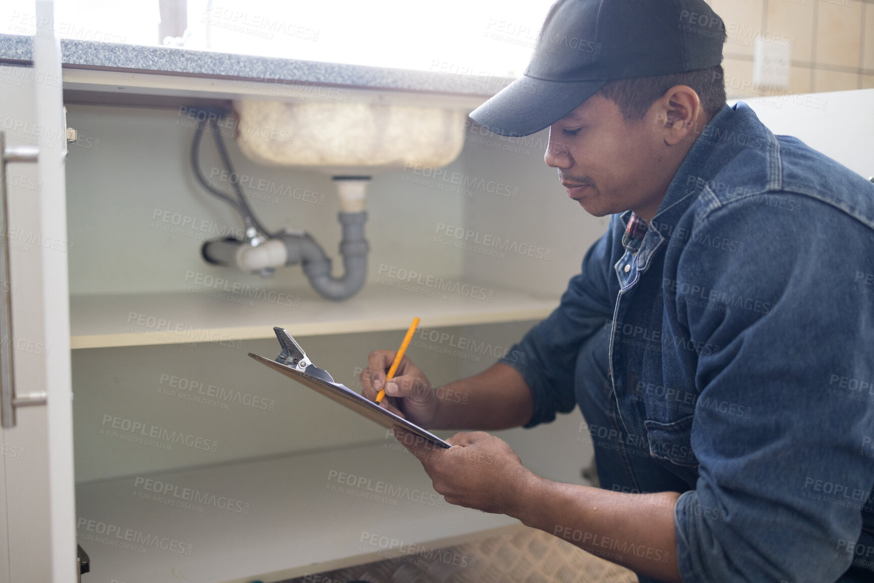 Buy stock photo Plumber writing, sink maintenance document and plumbing check of a handyman in a kitchen. Water installation, home repair checklist and builder in a household for building construction and inspection