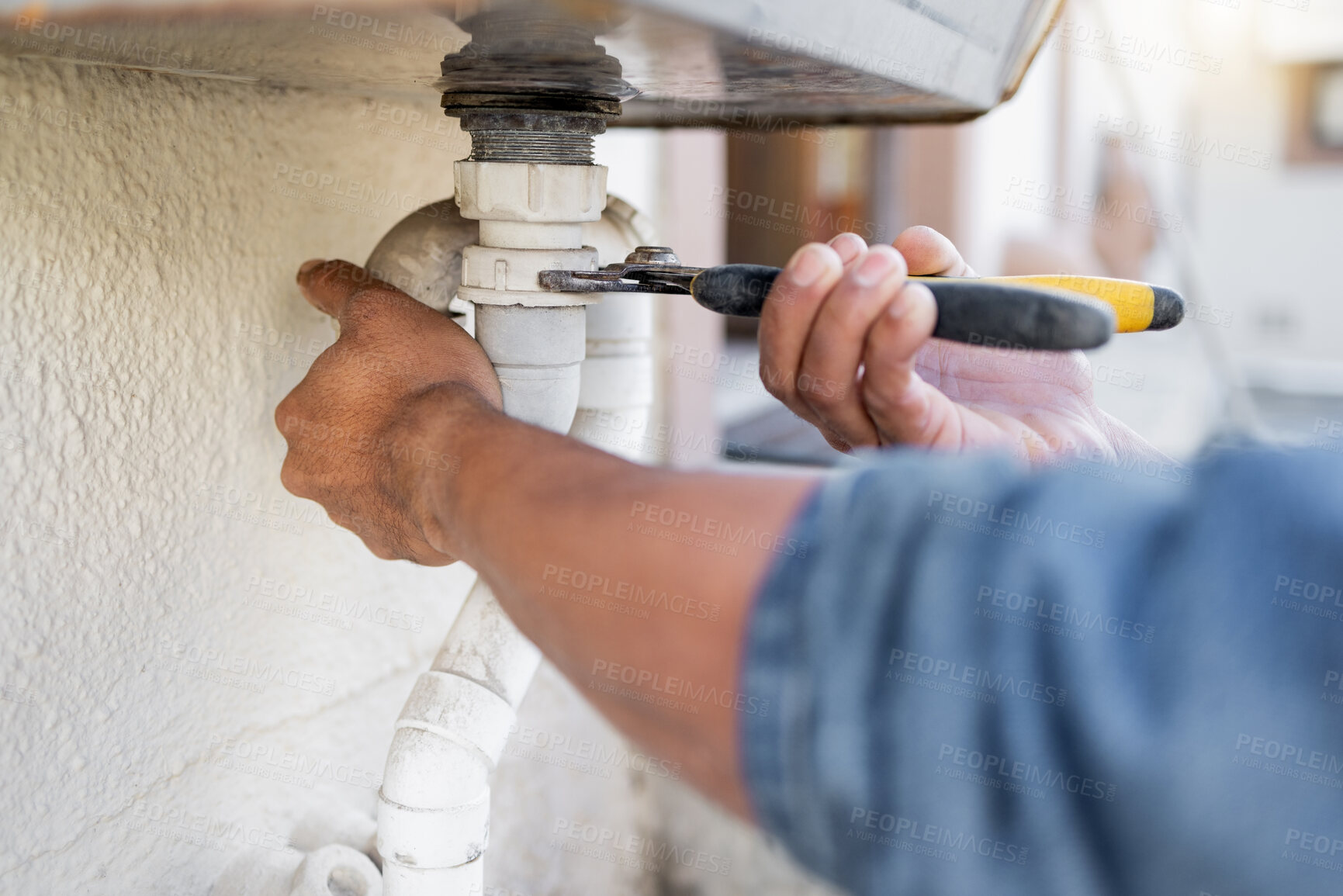 Buy stock photo Hands, plumber and wrench for pipe, maintenance and repairs, blockage and installation by man closeup. Plumbing, zoom and professional handyman fixing drain, system and replace with tool or equipment