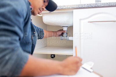 Buy stock photo Plumber, checklist and pipe in home kitchen, workplace or industry for property development vision. Black man, construction worker and writing with notes, idea and paper for diy, interior and design