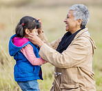 Happy Grandmother, young girl and nature walk of kid with senior woman in the countryside. Outdoor field, grass and elderly female with child on a family adventure on vacation with happiness and fun 