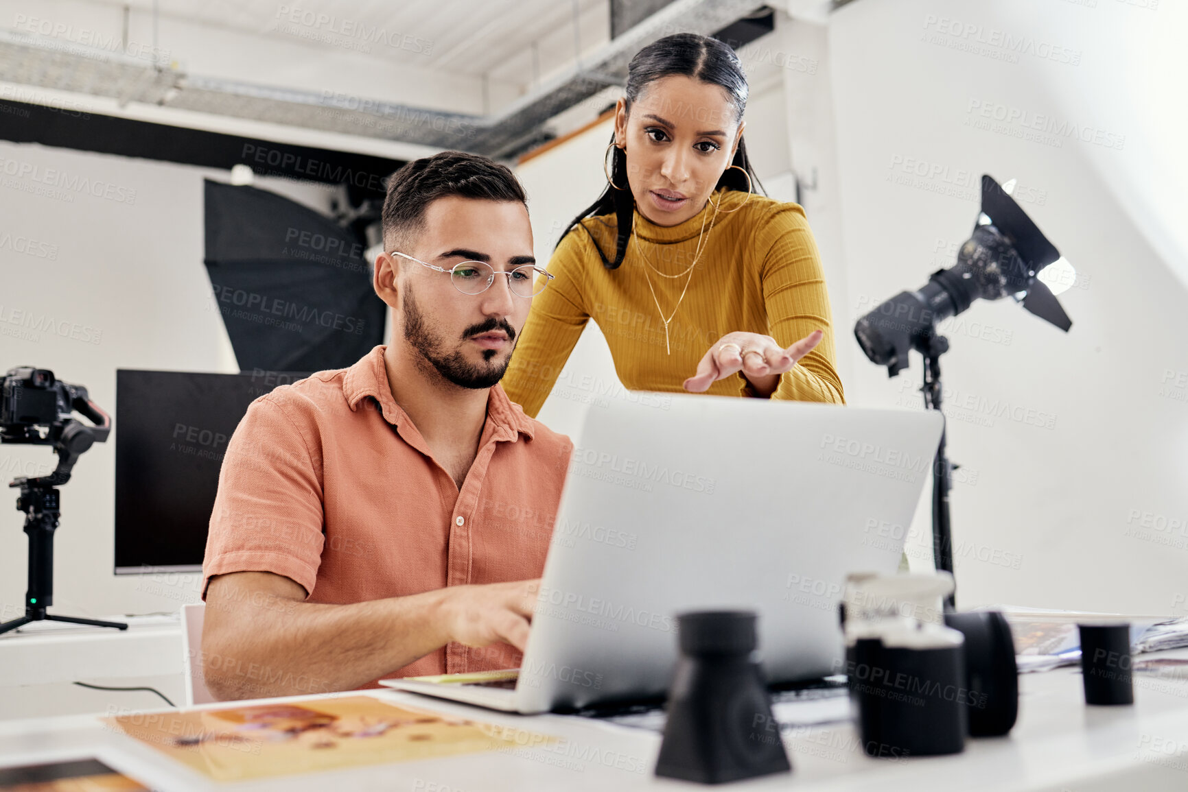 Buy stock photo Photography, laptop production edit and collaboration of creative design employee after photoshoot. Studio. teamwork and magazine shoot planning of photographer agency workers with communication